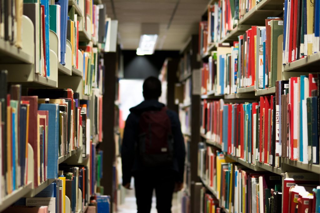 A man walks through a library